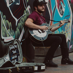 guitar player busking on street