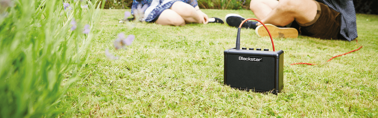 คุณภาพเสียงของแอมป์กีต้าร์ที่เกินตัว lifestyle image of Blackstar FLY in grass